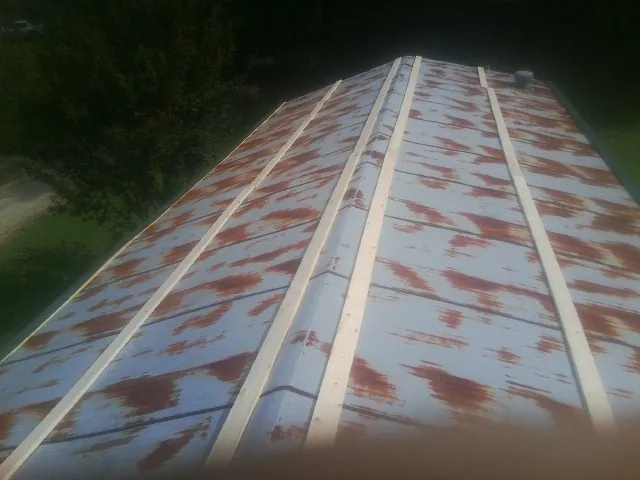 Rusted metal roof panels with new wood purlins before replacement — Storm Damage Roof Repair in Mills River by Roofing Brothers